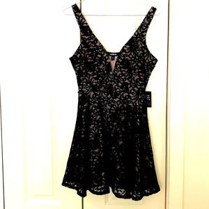 Beautiful/ unique Express black lace overlay dress,cream lining,attached shorts.